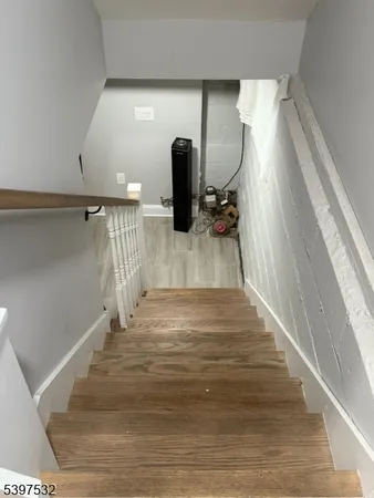 a view of hallway with wooden floor and fireplace