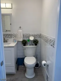 a bathroom with a toilet a sink and mirror