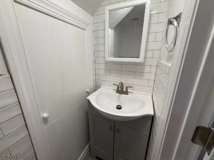 a bathroom with a sink a mirror and vanity