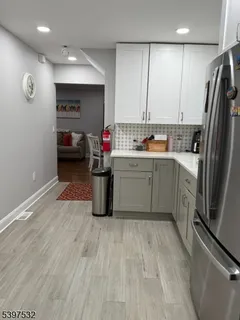 a kitchen with sink refrigerator and cabinets