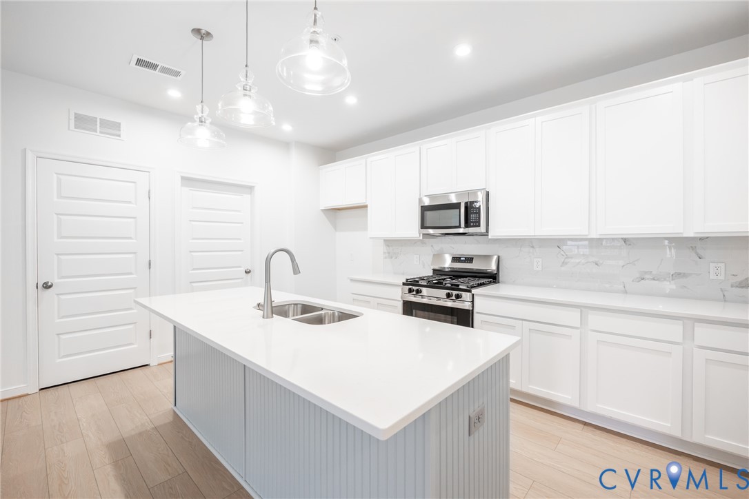 4005 Next Level Trace Midlothian, VA 23112 - Photo 1 of 28 a kitchen with a sink a stove and cabinets