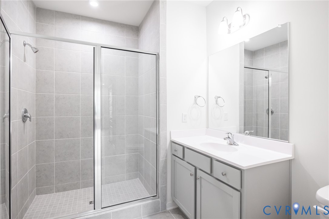 4005 Next Level Trace Midlothian, VA 23112 - Photo 13 of 28 a bathroom with a shower sink and mirror