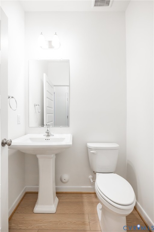 4005 Next Level Trace Midlothian, VA 23112 - Photo 15 of 28 a bathroom with a toilet a sink and mirror