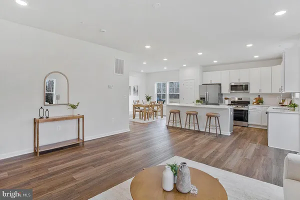 a dining room with furniture and wooden floor