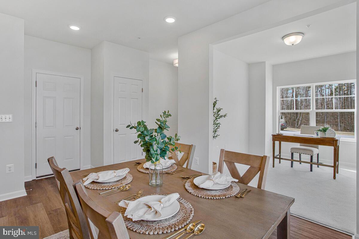 1225 Juniper Street Shady Side, MD 20764 - Photo 13 of 33 a view of a dining room with furniture a rug and wooden floor