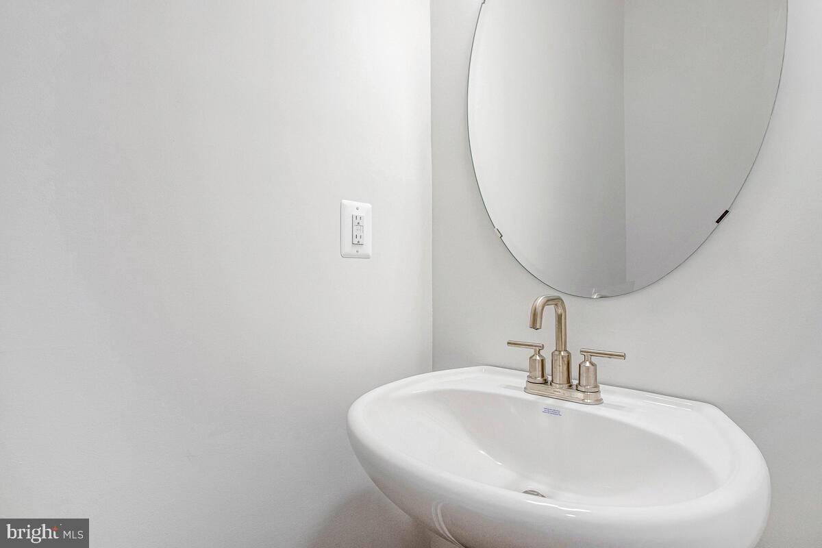 1225 Juniper Street Shady Side, MD 20764 - Photo 15 of 33 a bathroom with a sink and a mirror