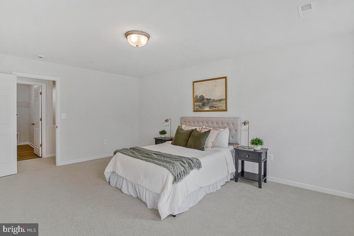 1225 Juniper Street Shady Side, MD 20764 - Photo 18 of 33 a bedroom with a bed and a lamp