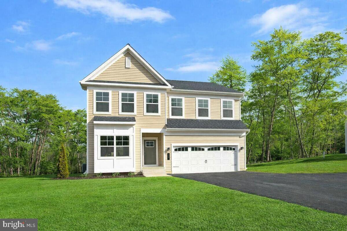 1225 Juniper Street Shady Side, MD 20764 - Photo 1 of 32 a front view of a house with a yard and garage
