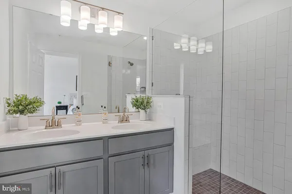 a bathroom with a sink a large mirror and vanity