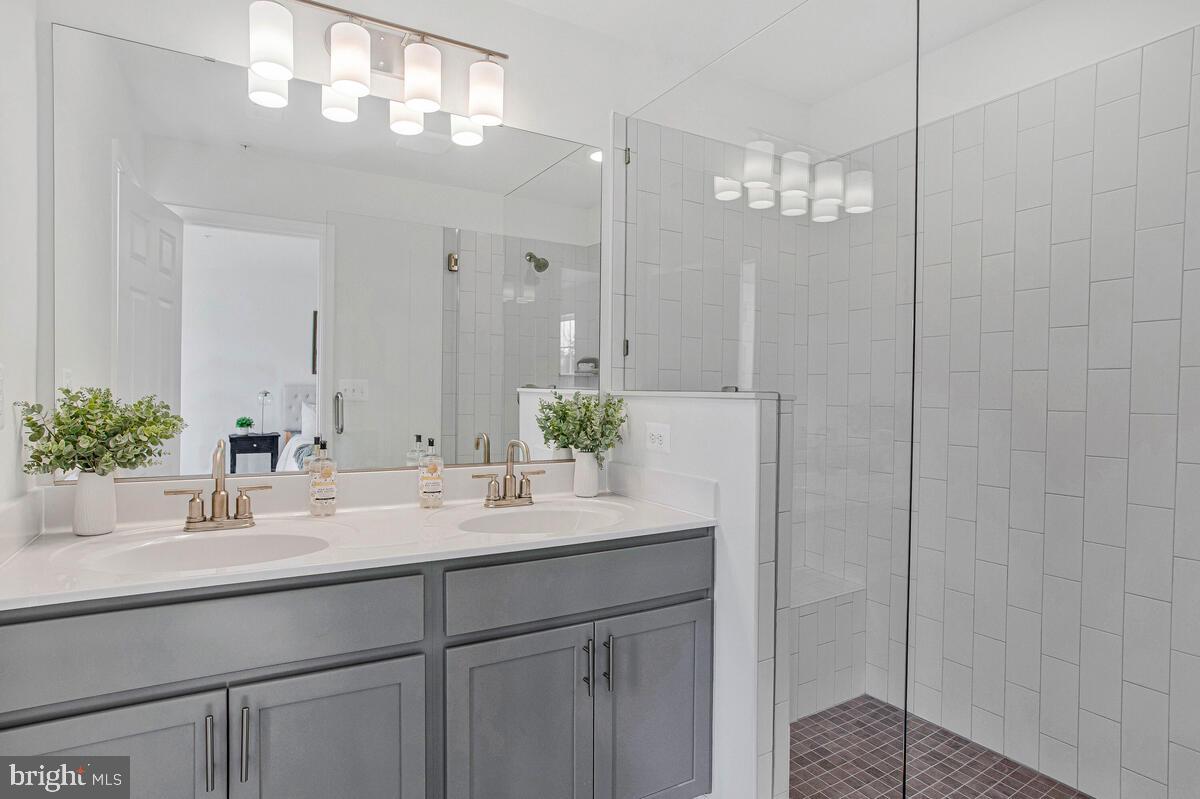 1225 Juniper Street Shady Side, MD 20764 - Photo 21 of 33 a bathroom with a sink a large mirror and vanity