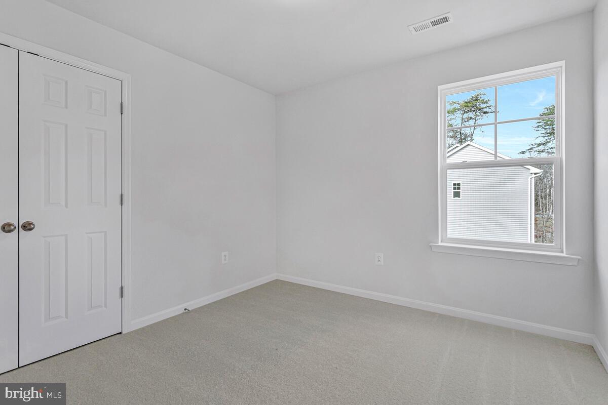 1225 Juniper Street Shady Side, MD 20764 - Photo 29 of 33 an empty room with windows and closet