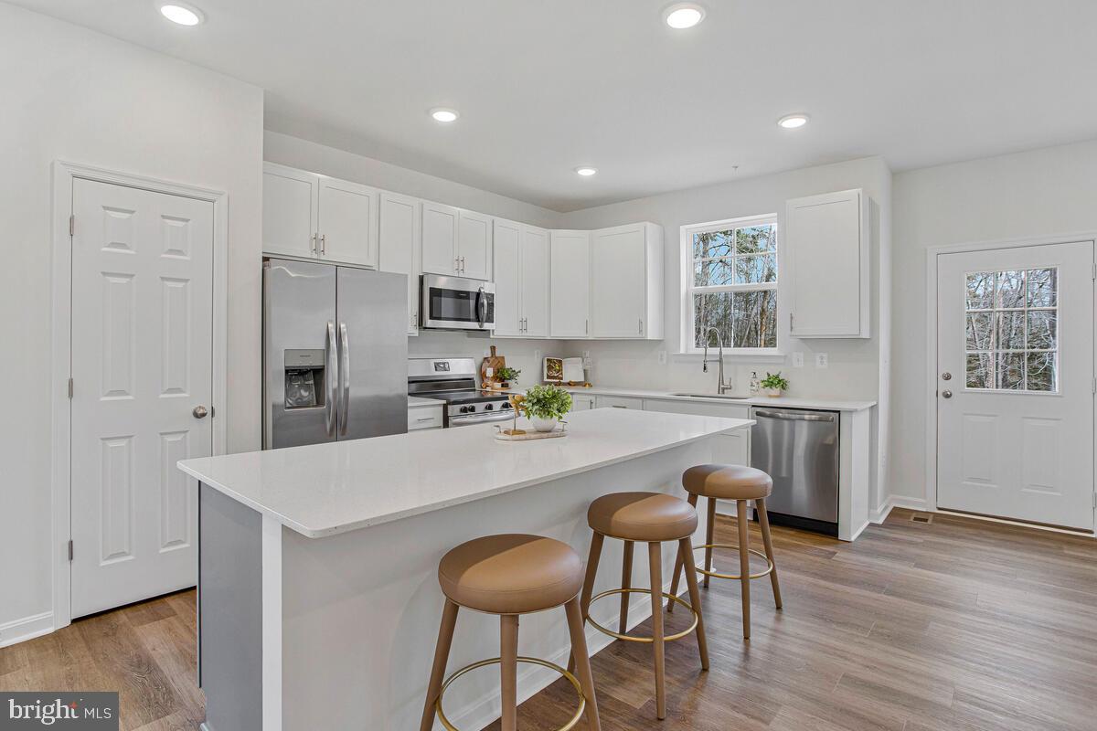 1225 Juniper Street Shady Side, MD 20764 - Photo 3 of 33 a large kitchen with a table and chairs