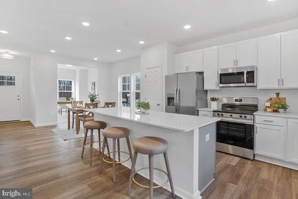 a large kitchen with a table and chairs