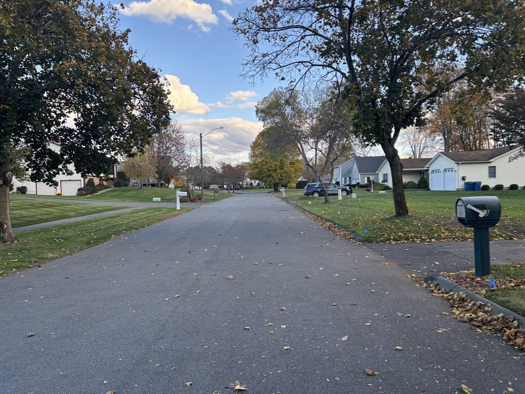 43 Wishing Well Way West Springfield, MA 01089 - Photo 42 of 42 a view of a street with a bench and trees