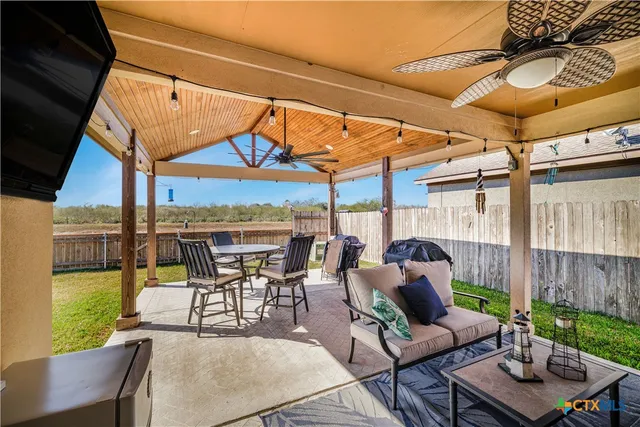 a view of a patio with a table and chairs
