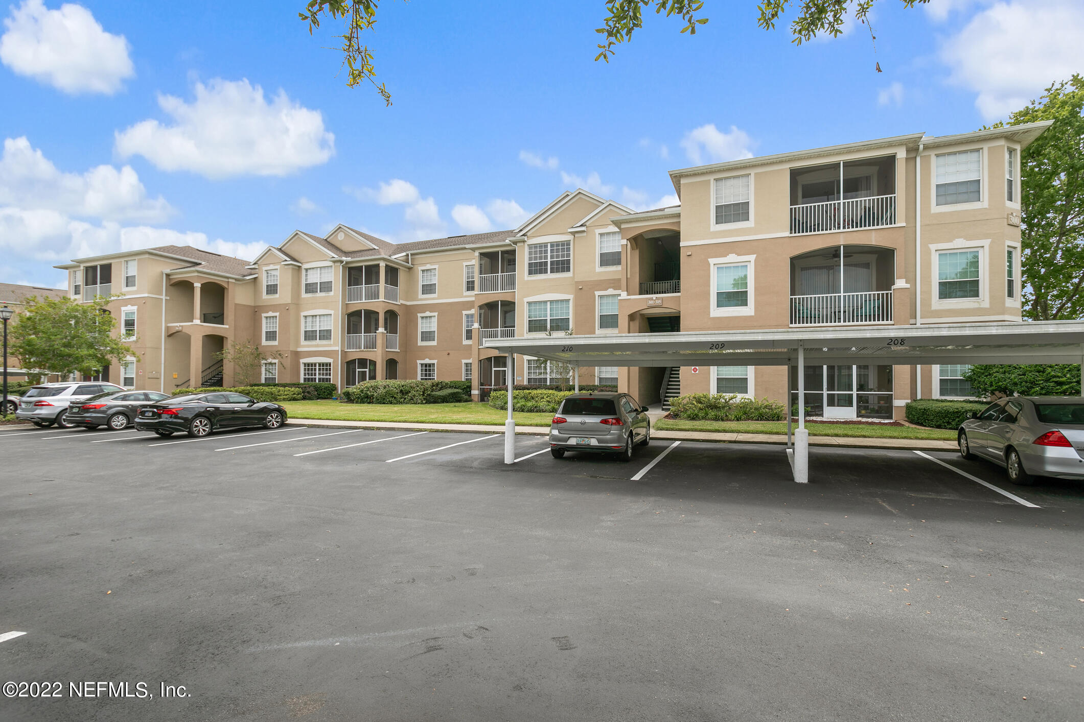 7990 Baymeadows Road, Unit 303 Jacksonville, FL 32256 - Photo 1 of 40 a view of a street with couches and a barbeque