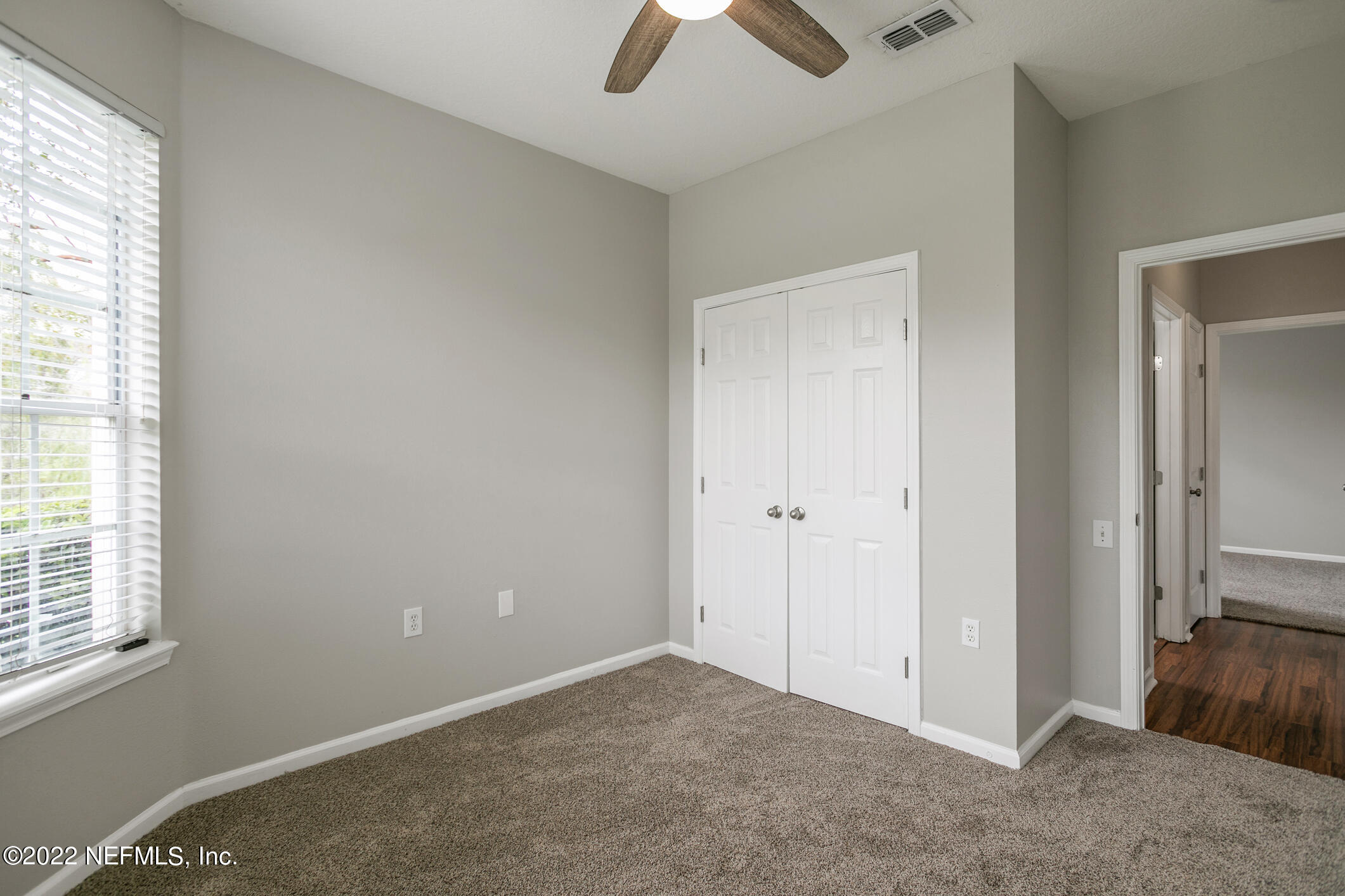 7990 Baymeadows Road, Unit 303 Jacksonville, FL 32256 - Photo 14 of 40 an empty room with chandelier fan and windows