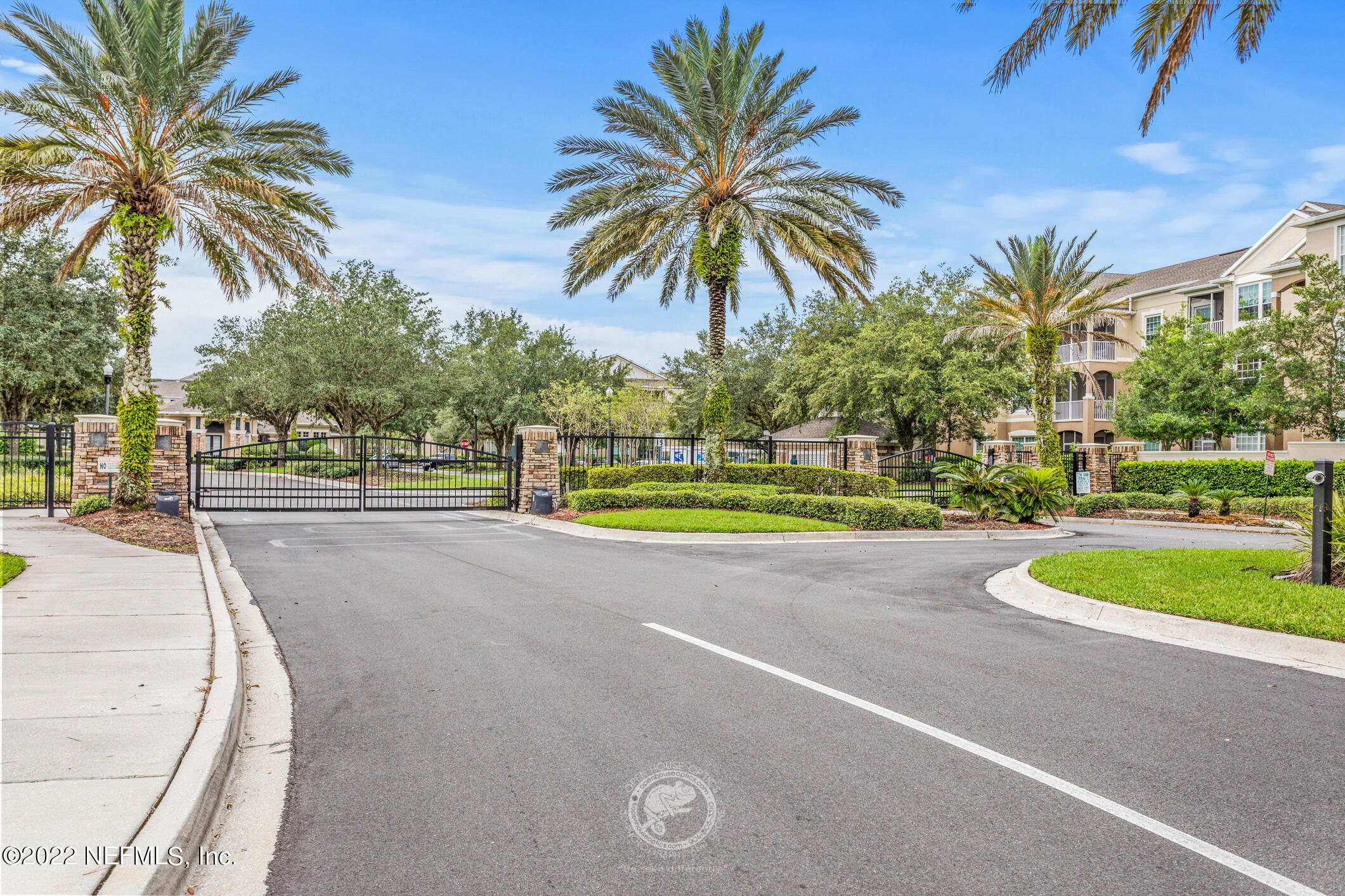 7990 Baymeadows Road, Unit 303 Jacksonville, FL 32256 - Photo 25 of 40 a view of a swimming pool with a yard and palm trees