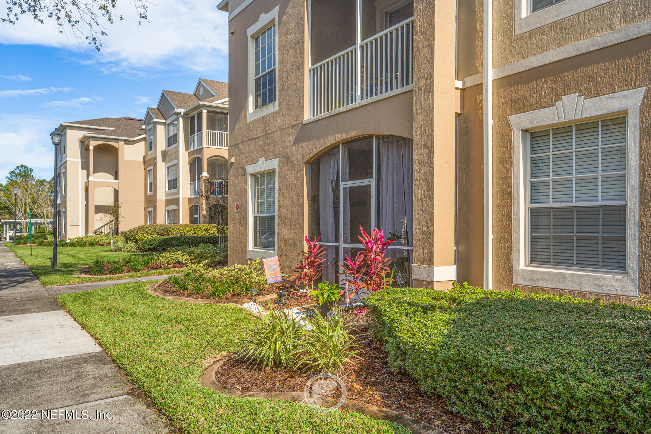 7990 Baymeadows Road, Unit 303 Jacksonville, FL 32256 - Photo 27 of 40 a front view of a house with a yard