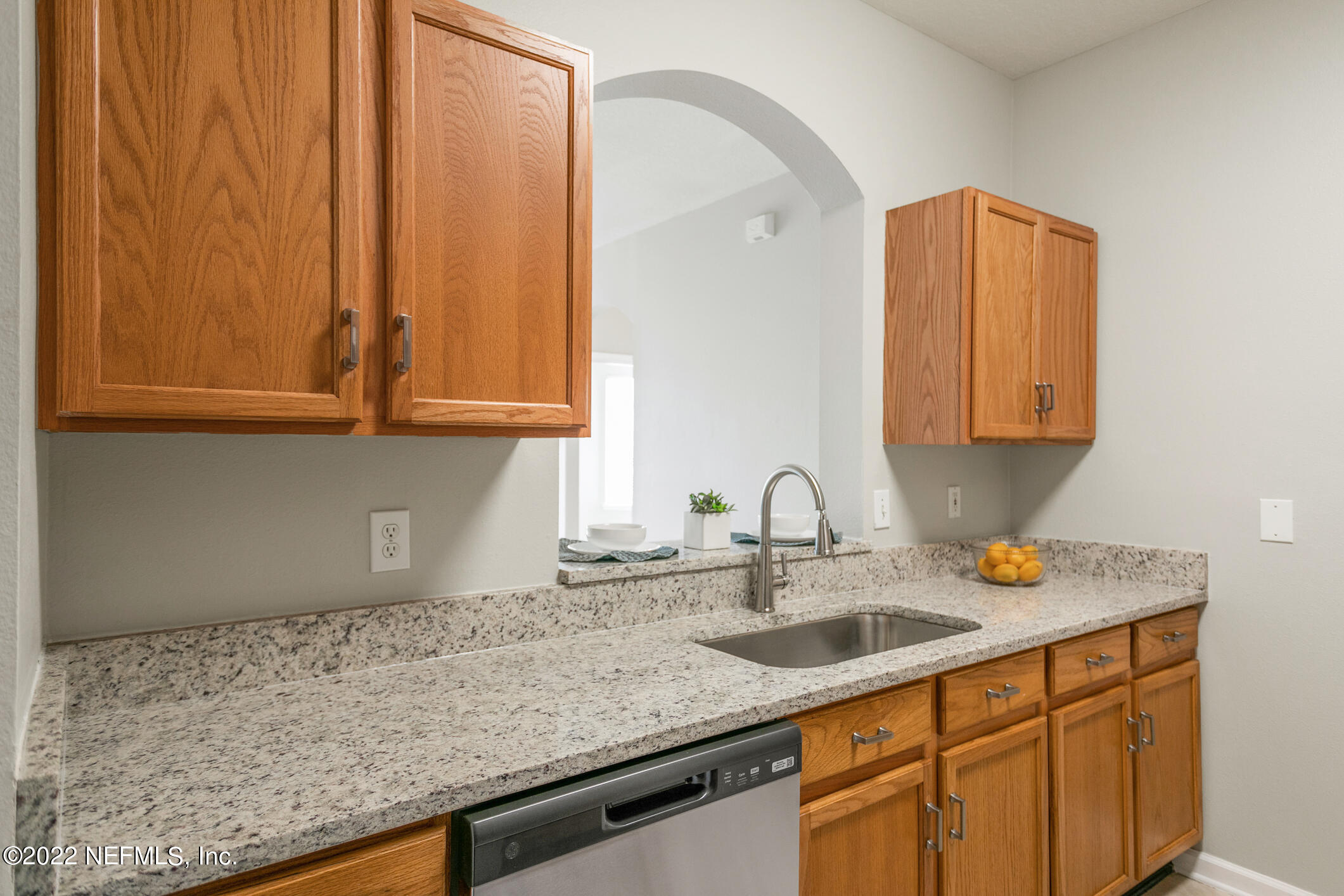 7990 Baymeadows Road, Unit 303 Jacksonville, FL 32256 - Photo 6 of 40 a kitchen with sink cabinets and a wooden floor
