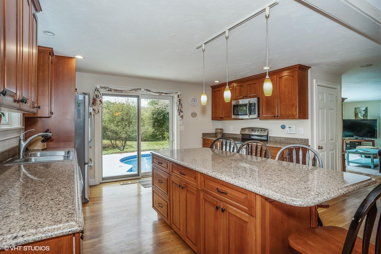 20 Lords Pond Road Chatham, MA 02650 - Photo 5 of 28 a kitchen with granite countertop a sink a counter top space and living room area
