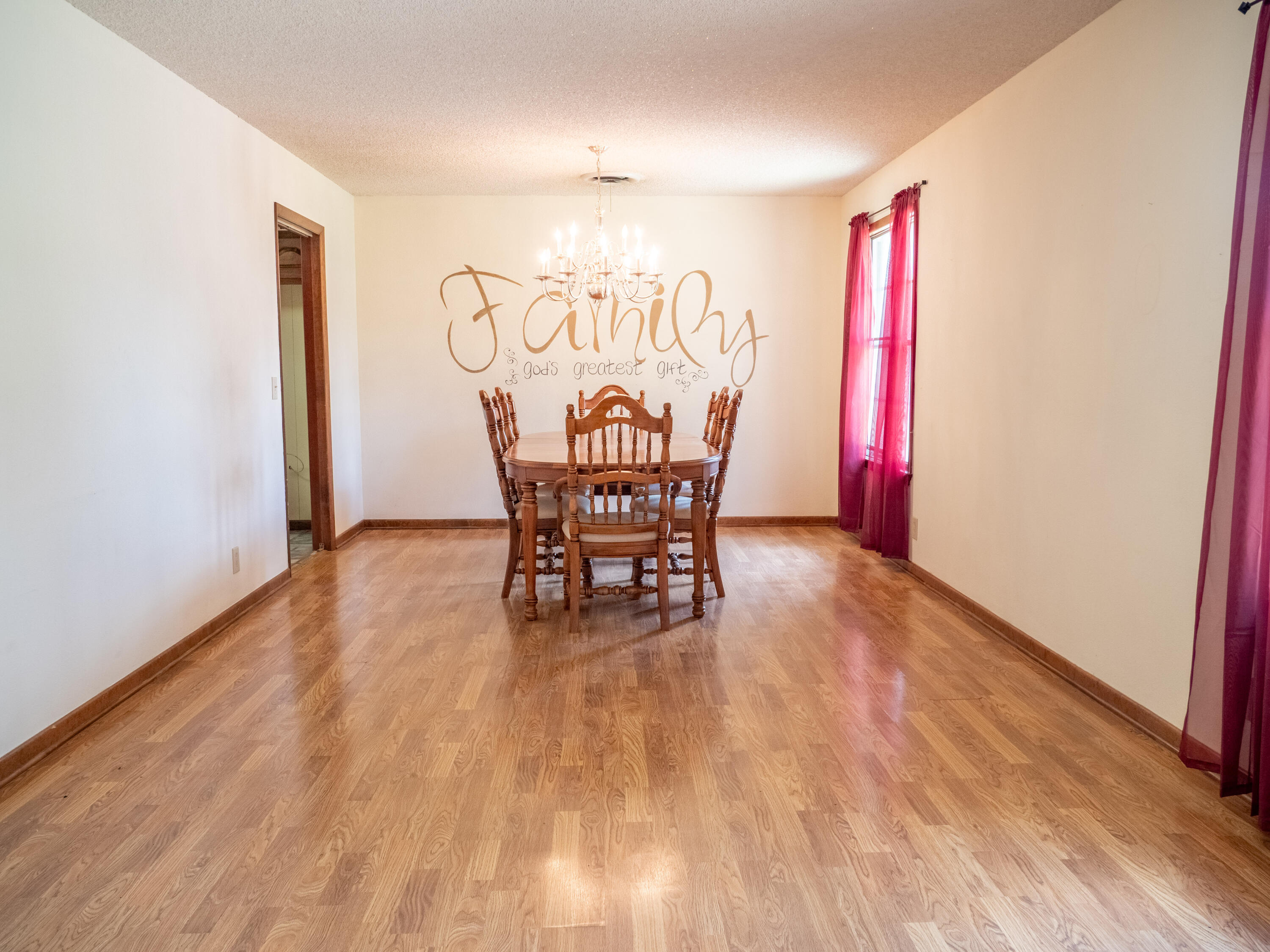 303 Comanche Trail Tulia, TX 79088 - Photo 16 of 37 a view of a dining room with furniture and wooden floor