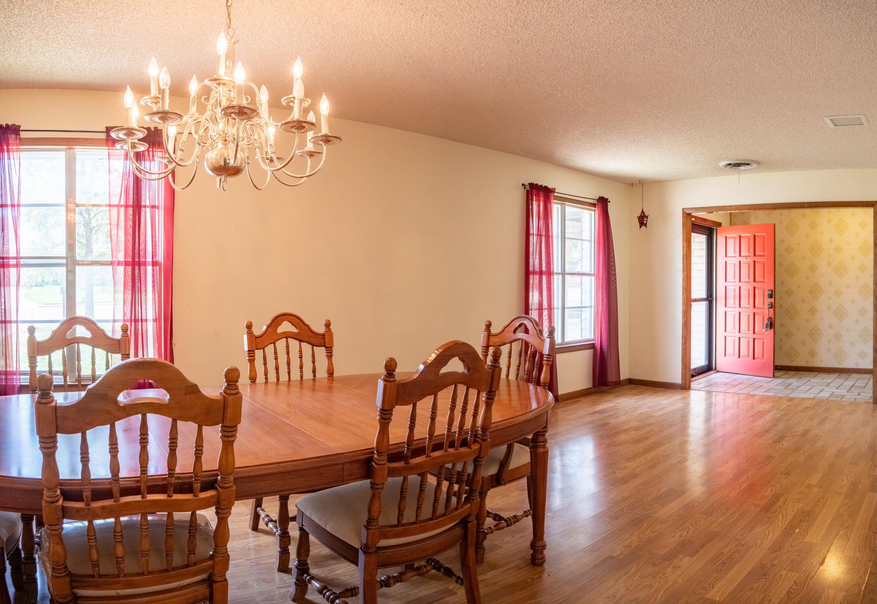 303 Comanche Trail Tulia, TX 79088 - Photo 17 of 37 a view of a dining room with furniture wooden floor and chandelier