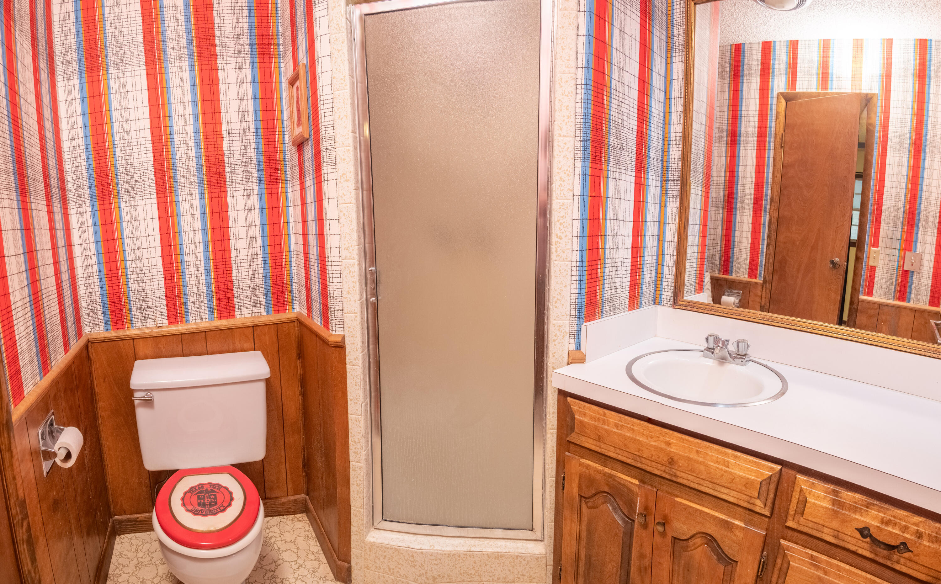 303 Comanche Trail Tulia, TX 79088 - Photo 24 of 37 a bathroom with a sink and a mirror