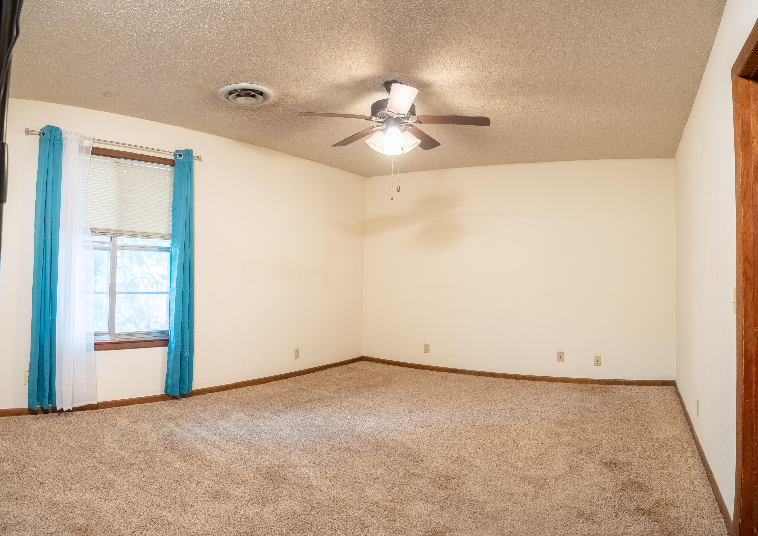 303 Comanche Trail Tulia, TX 79088 - Photo 28 of 37 an empty room with a ceiling fan and a window