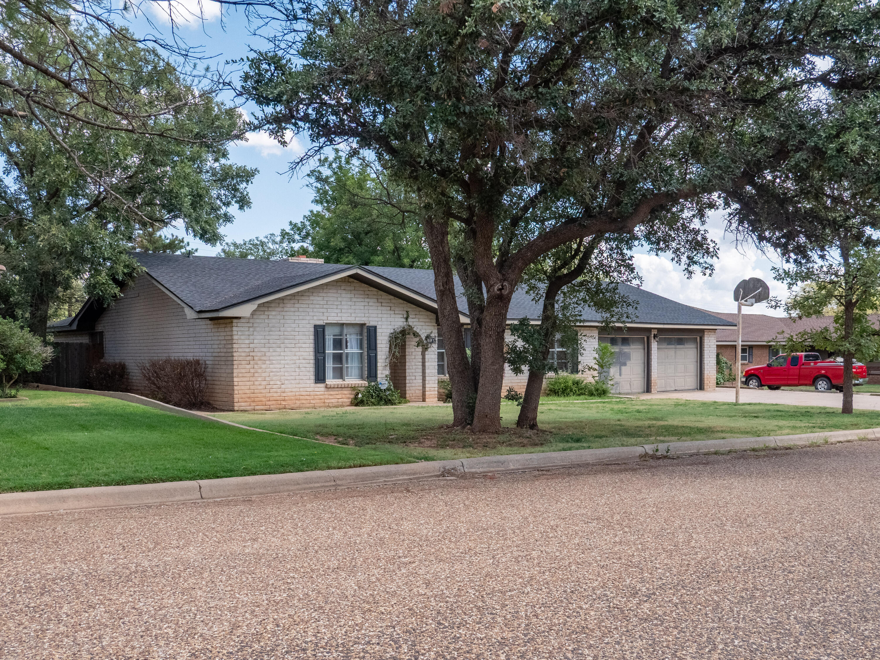 303 Comanche Trail Tulia, TX 79088 - Photo 3 of 37 a small house with a tree in front of it