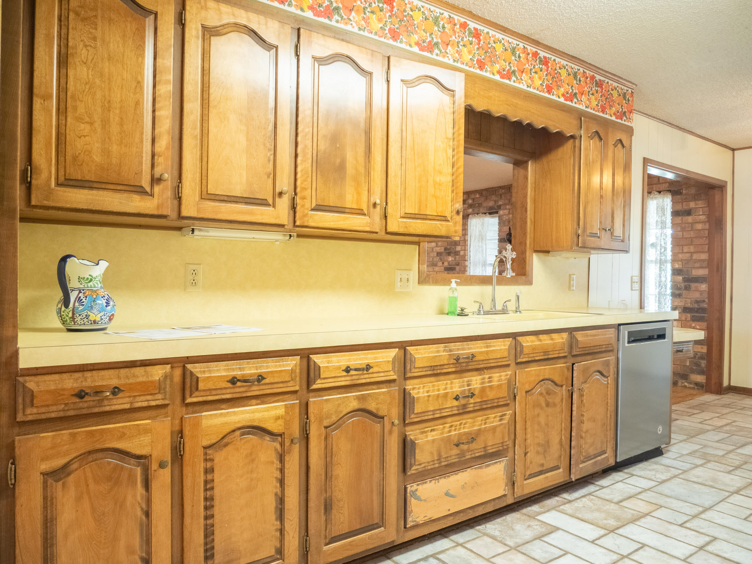303 Comanche Trail Tulia, TX 79088 - Photo 9 of 37 a bathroom with a sink a mirror and next to a window