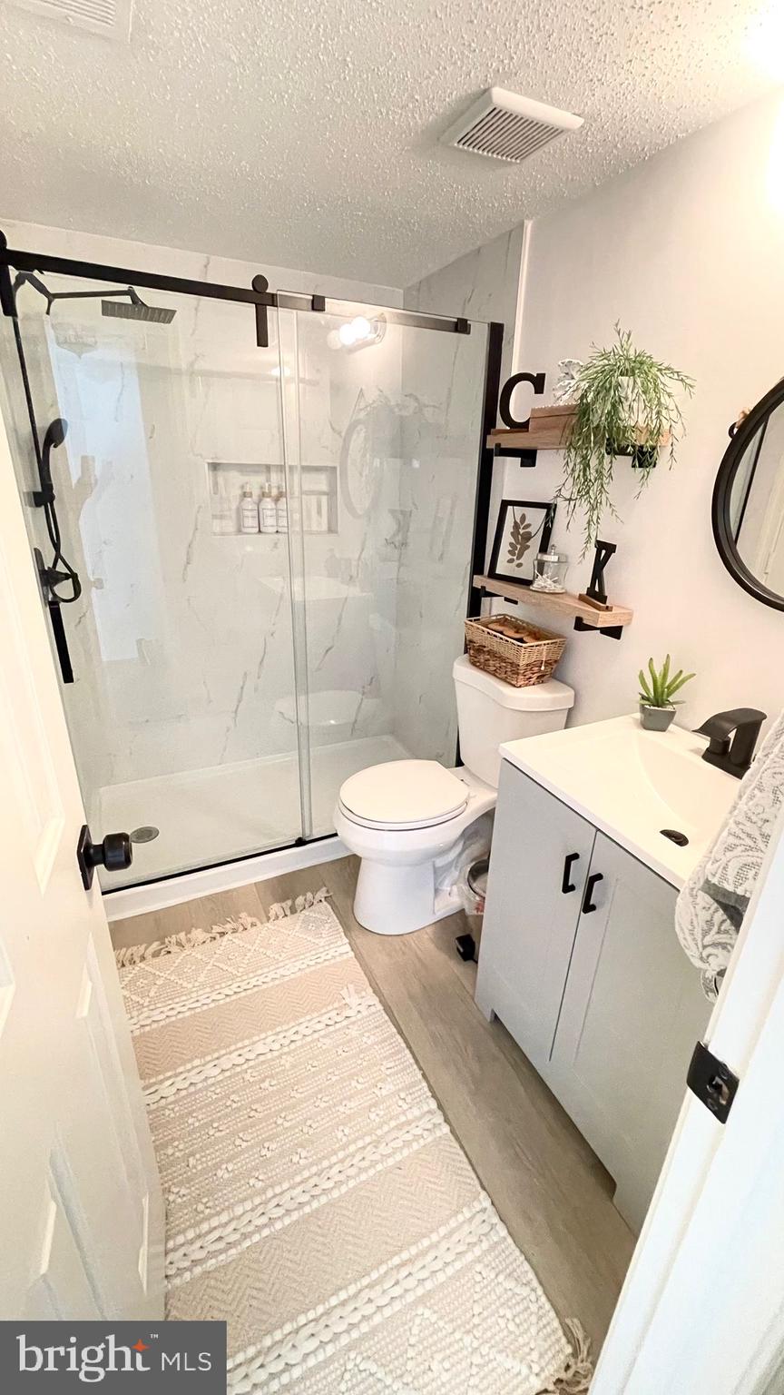 124 Fort Evans Road Southeast, Unit C Leesburg, VA 20175 - Photo 13 of 21 a bathroom with a toilet sink and shower