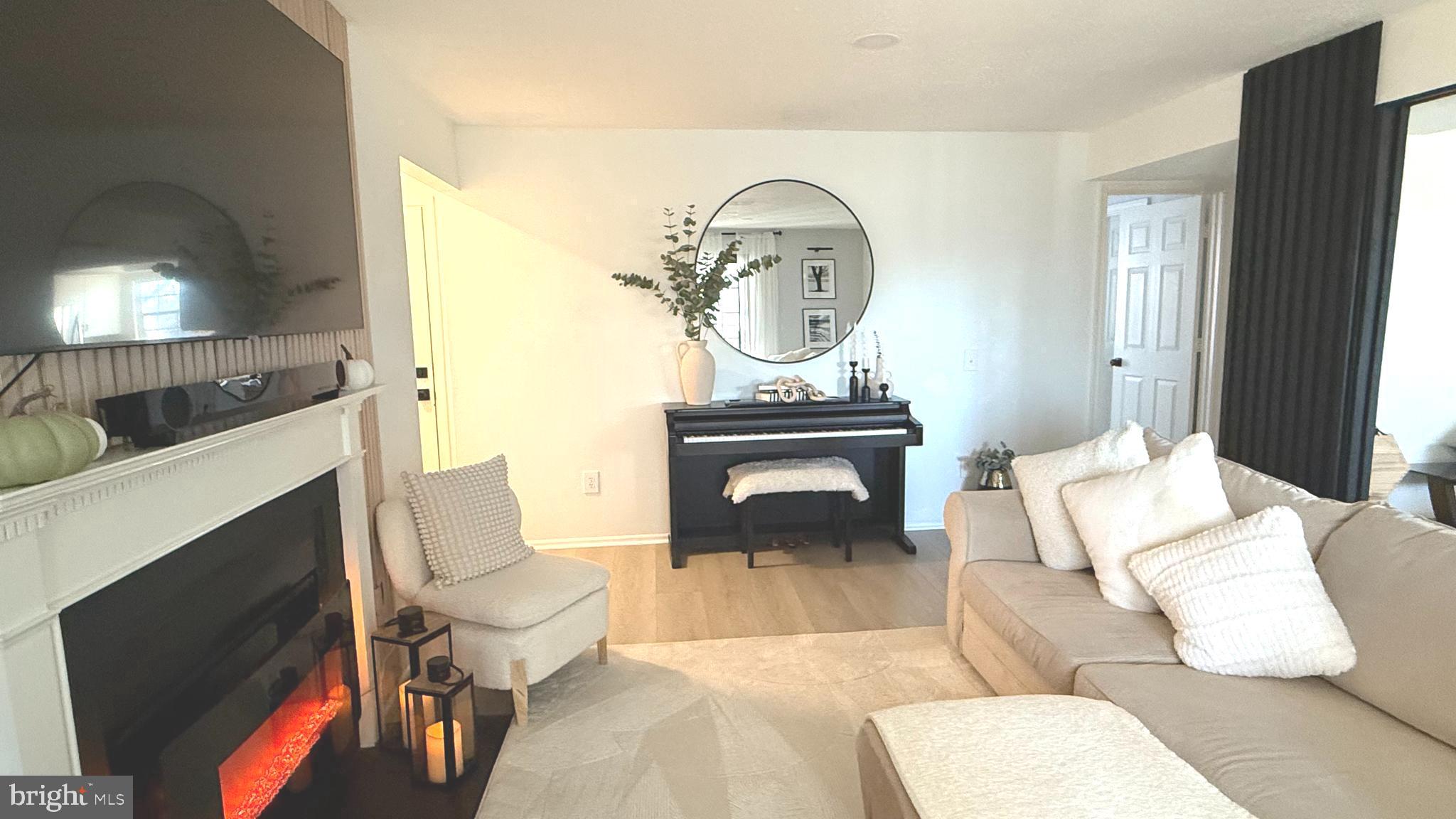 124 Fort Evans Road Southeast, Unit C Leesburg, VA 20175 - Photo 4 of 21 a living room with furniture a flat screen tv and a fireplace