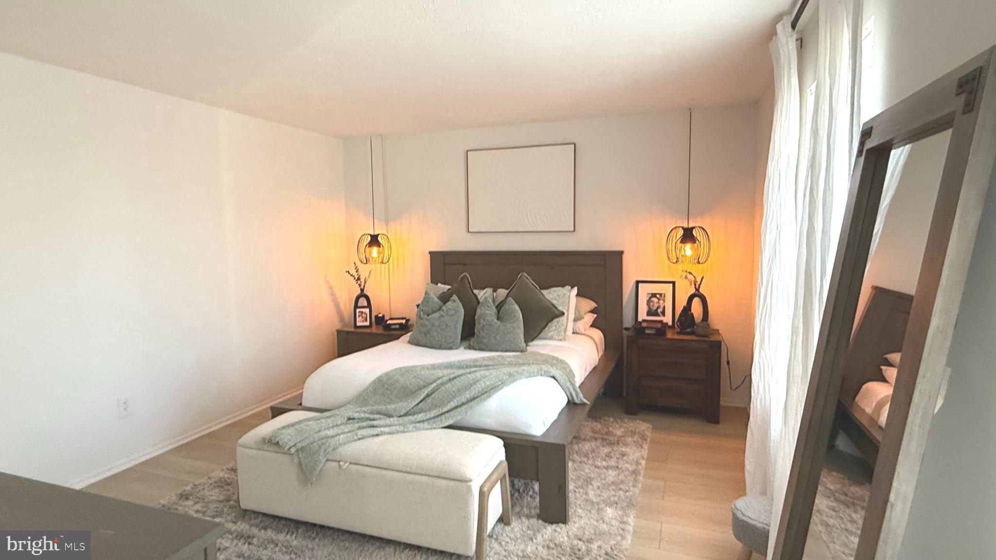 124 Fort Evans Road Southeast, Unit C Leesburg, VA 20175 - Photo 10 of 21 a bedroom with a bed and a mirror