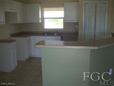 3204 35th Street Southwest Lehigh Acres, FL 33976 - Photo 2 of 3 a kitchen with a sink cabinets and window