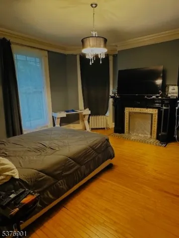 a bedroom with a bed and a television