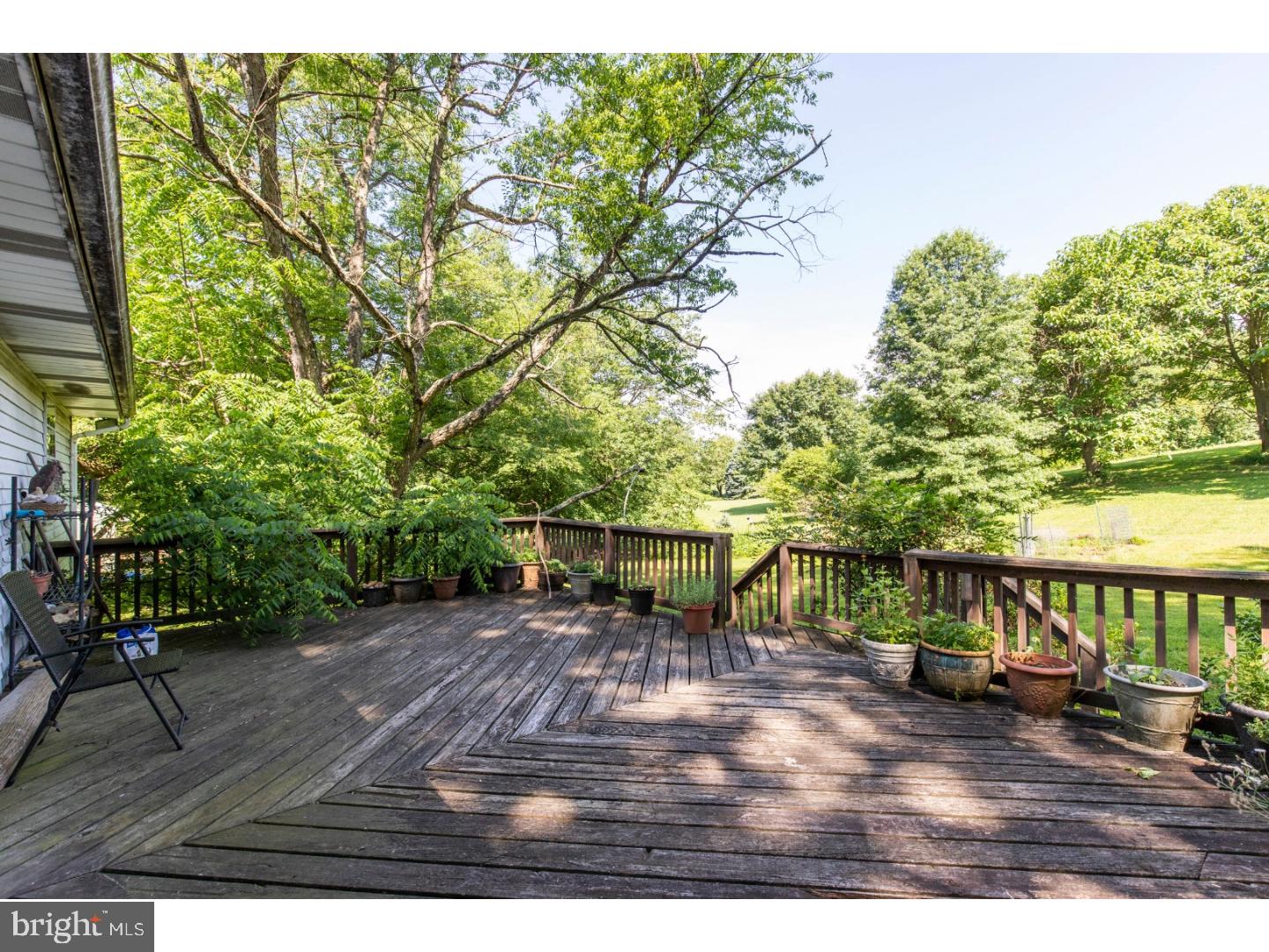 108 Peacedale Road Landenberg, PA 19350 - Photo 19 of 25 a view of a patio with table and chairs with wooden floor and fence