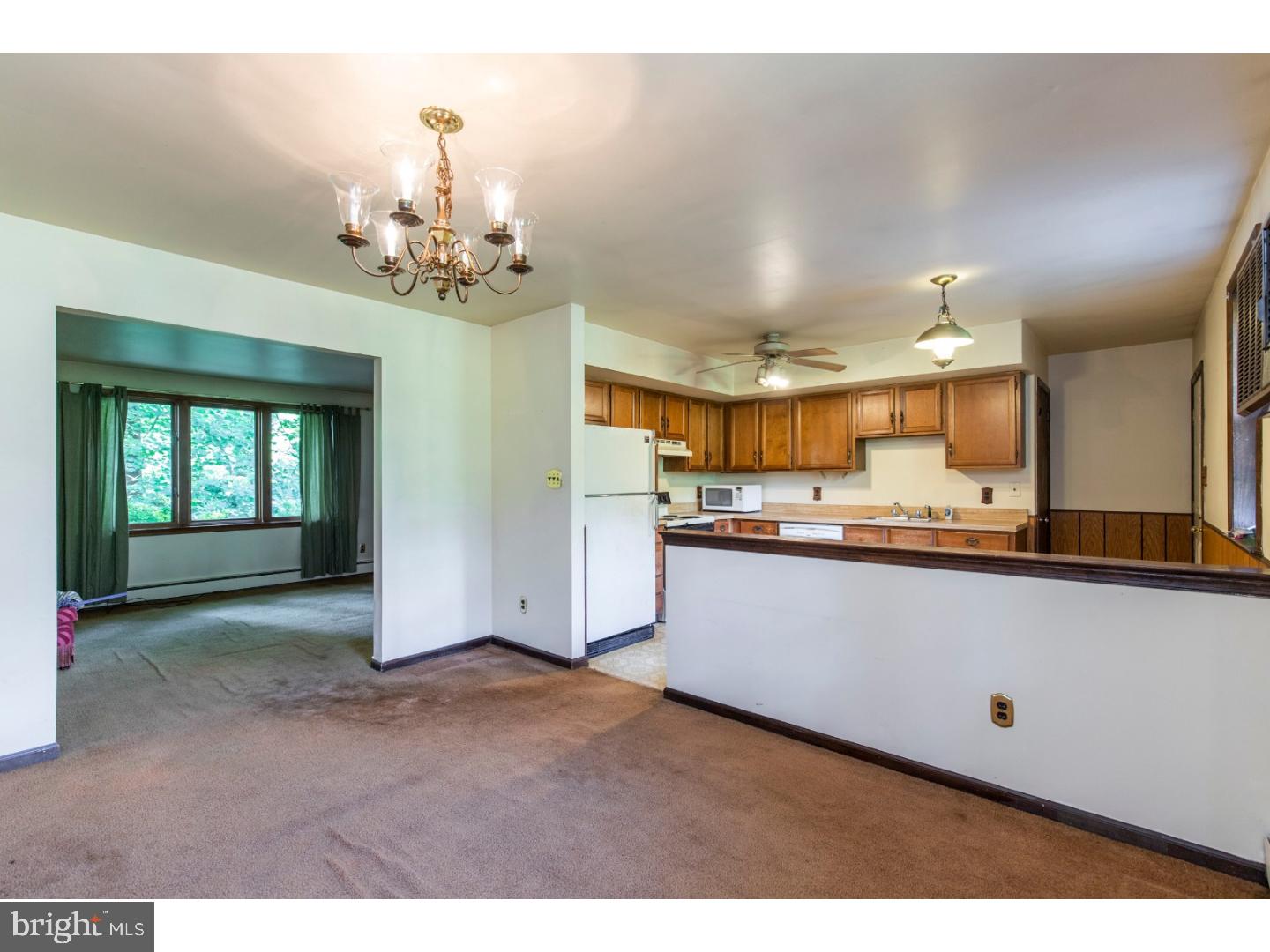108 Peacedale Road Landenberg, PA 19350 - Photo 5 of 25 a living room with kitchen island granite countertop furniture and a fireplace