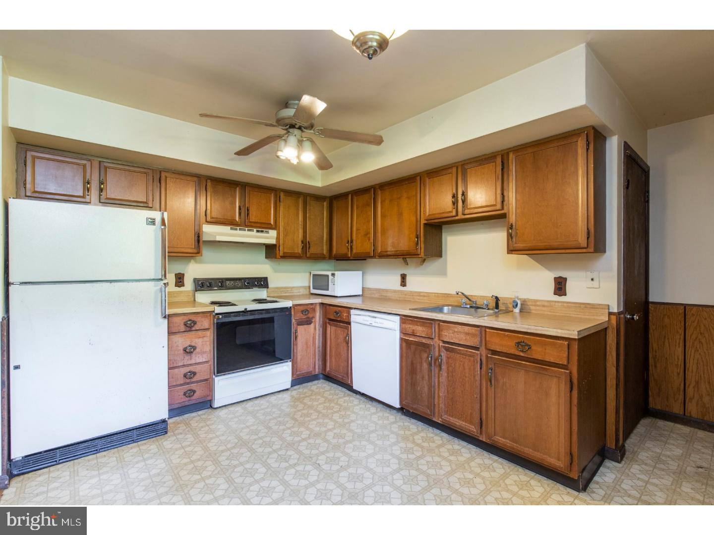 108 Peacedale Road Landenberg, PA 19350 - Photo 6 of 25 a kitchen with stainless steel appliances granite countertop a refrigerator a sink dishwasher a stove top oven a kitchen island and chairs with wooden floor