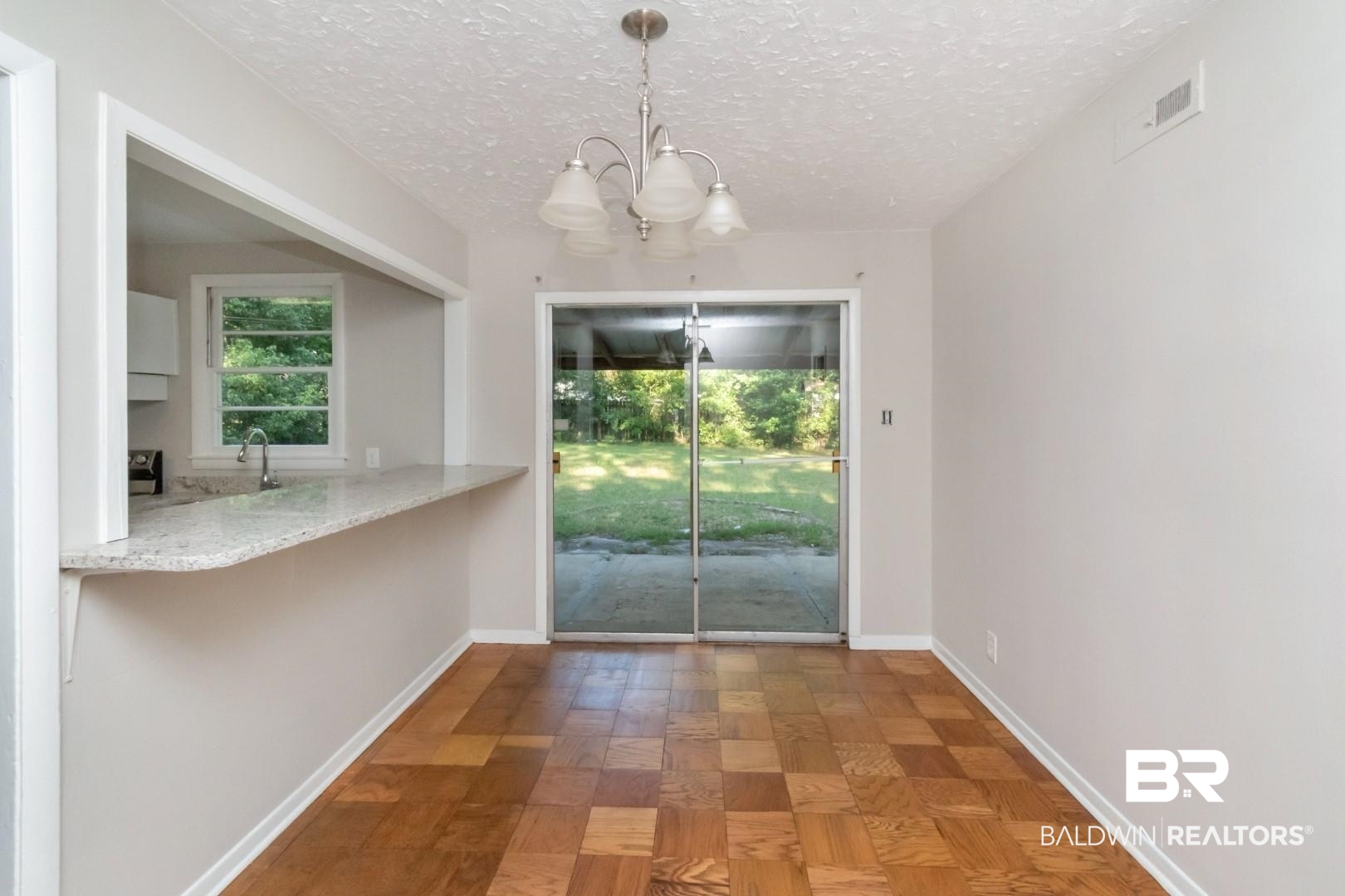 1220 Garland Drive Mobile, AL 36618 - Photo 9 of 25 Unfurnished dining area with parquet flooring, sink, a textured ceiling, and a chandelier