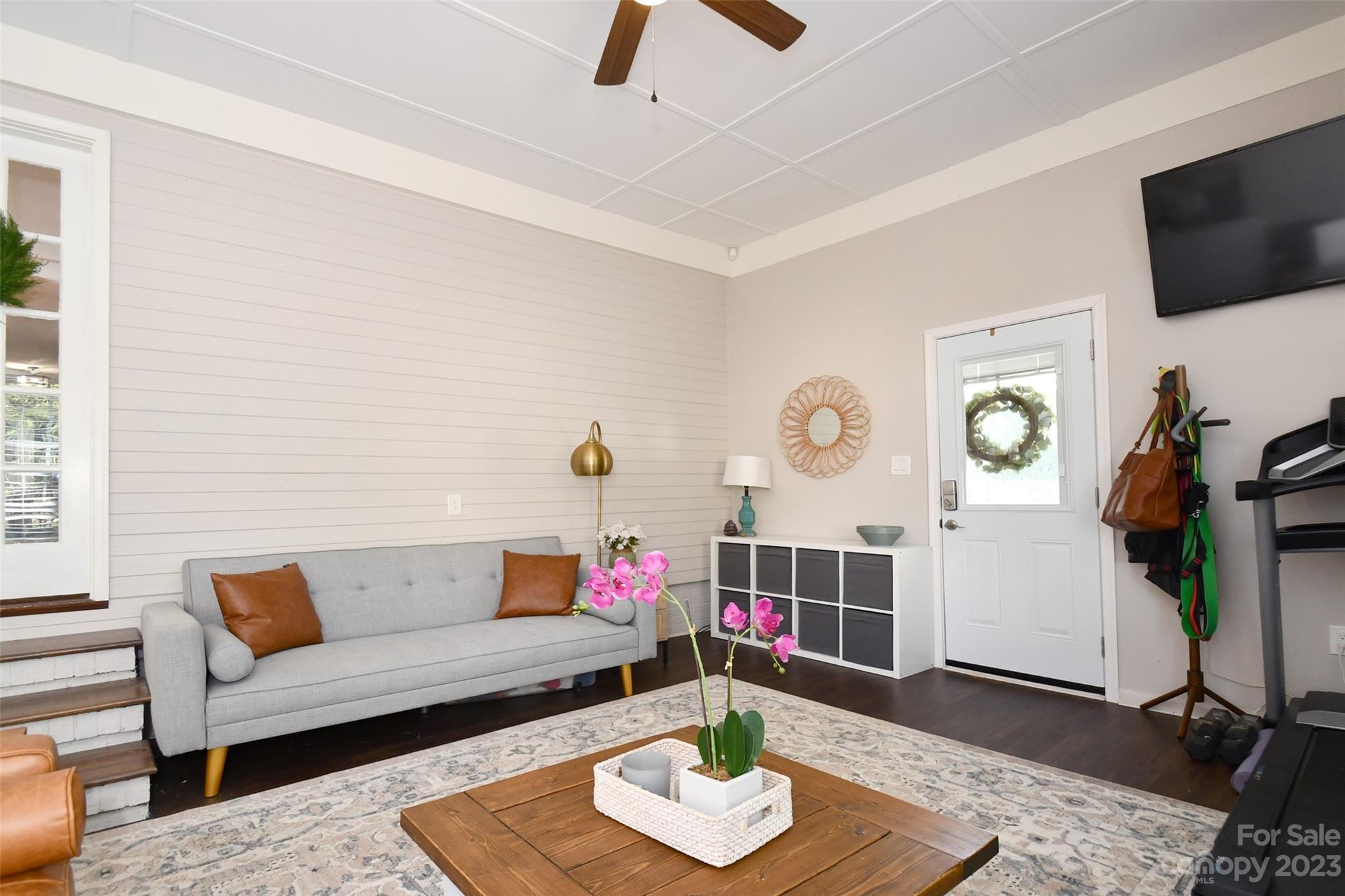 8017 Tottenham Drive Harrisburg, NC 28075 - Photo 20 of 36 a living room with furniture and a flat screen tv