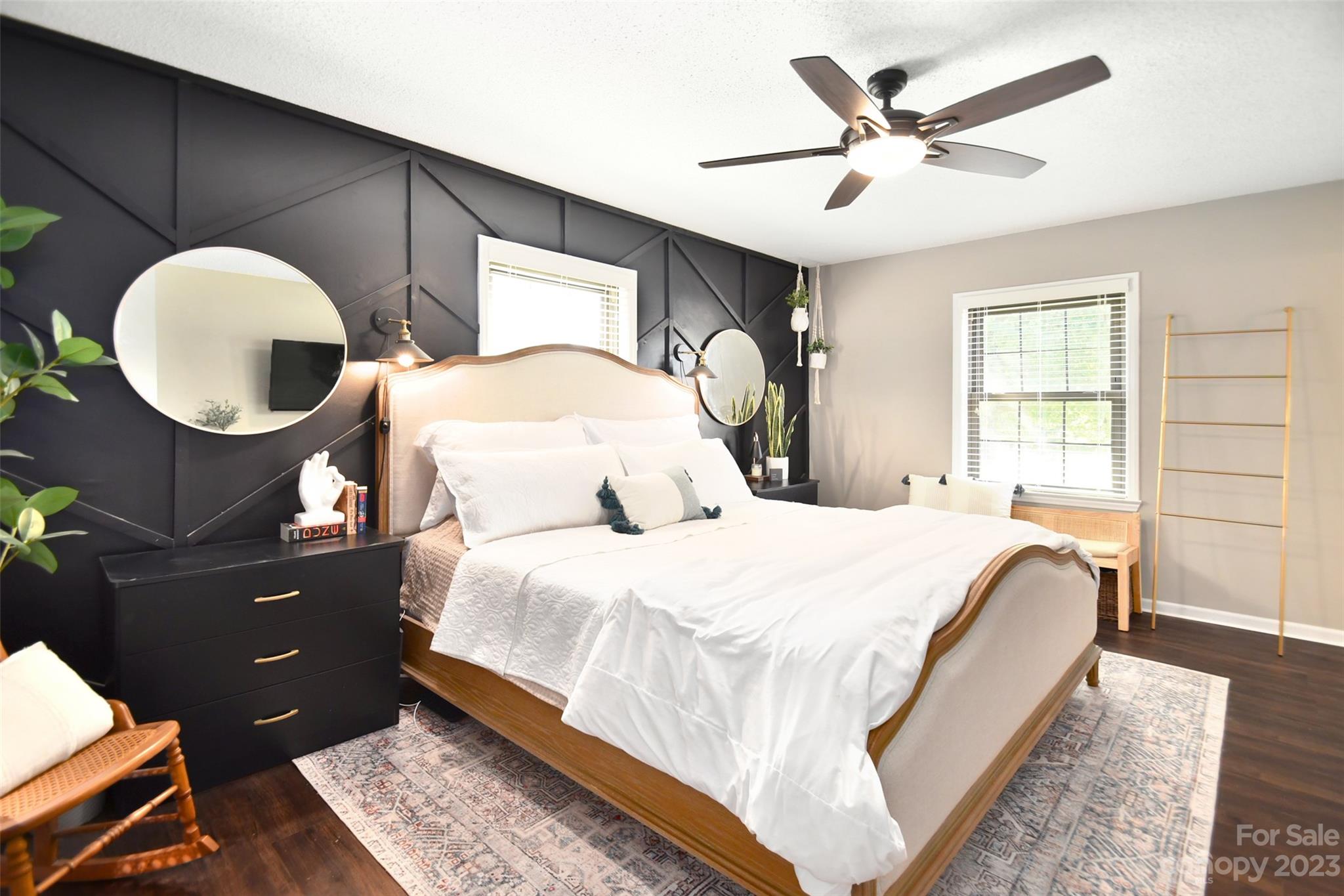 8017 Tottenham Drive Harrisburg, NC 28075 - Photo 24 of 36 a spacious bedroom with a bed and a chandelier