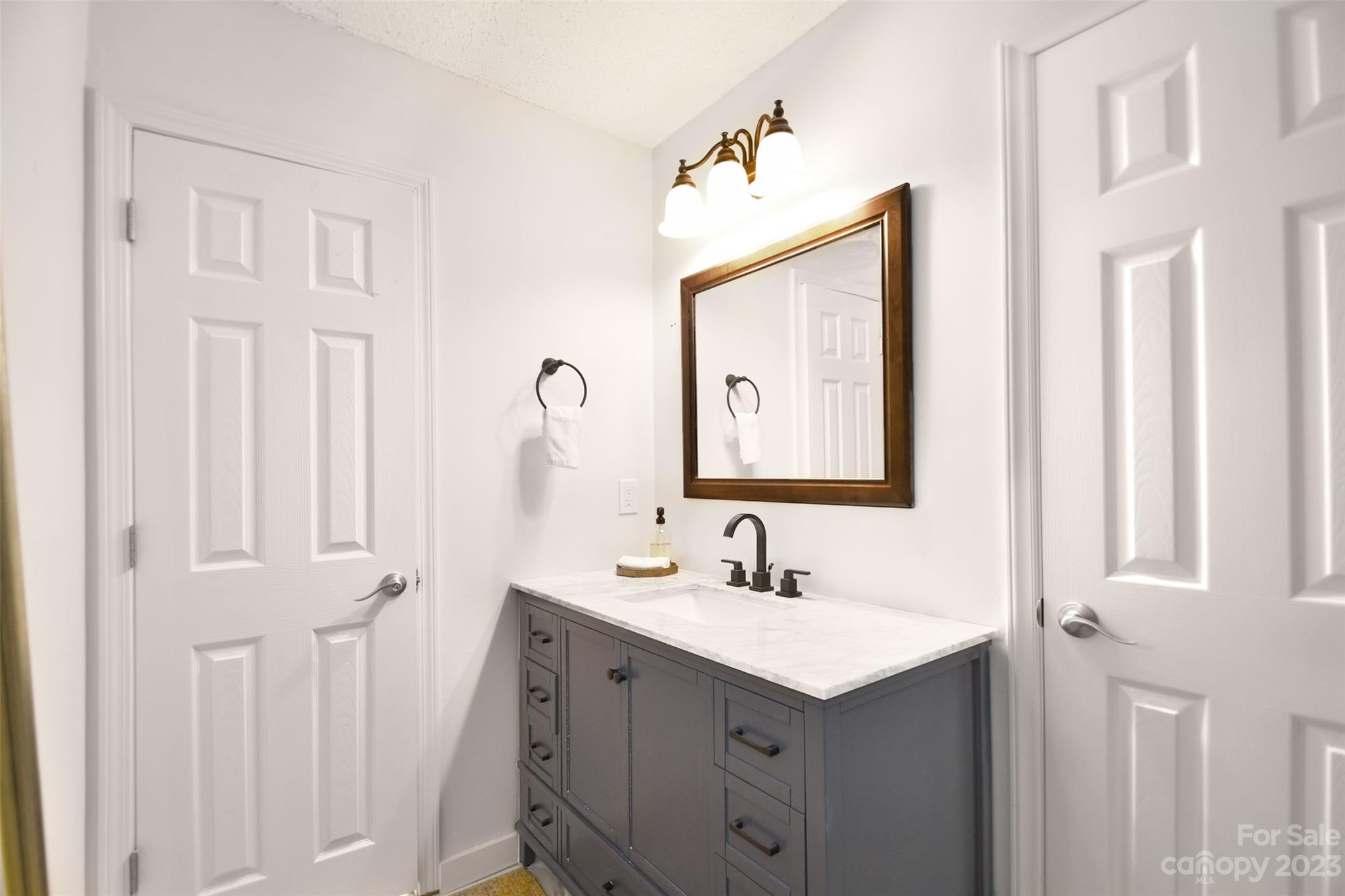 8017 Tottenham Drive Harrisburg, NC 28075 - Photo 25 of 36 a bathroom with a sink vanity and a mirror