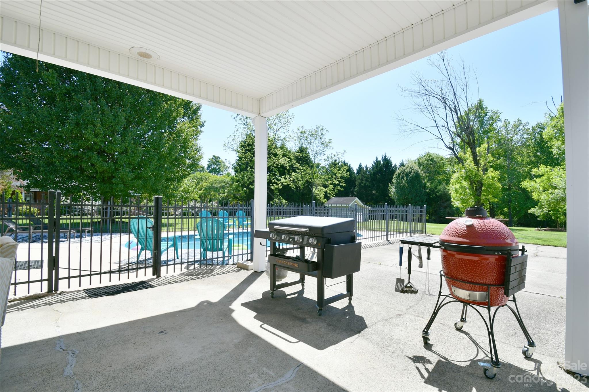 8017 Tottenham Drive Harrisburg, NC 28075 - Photo 28 of 36 a view of backyard with a table and chairs