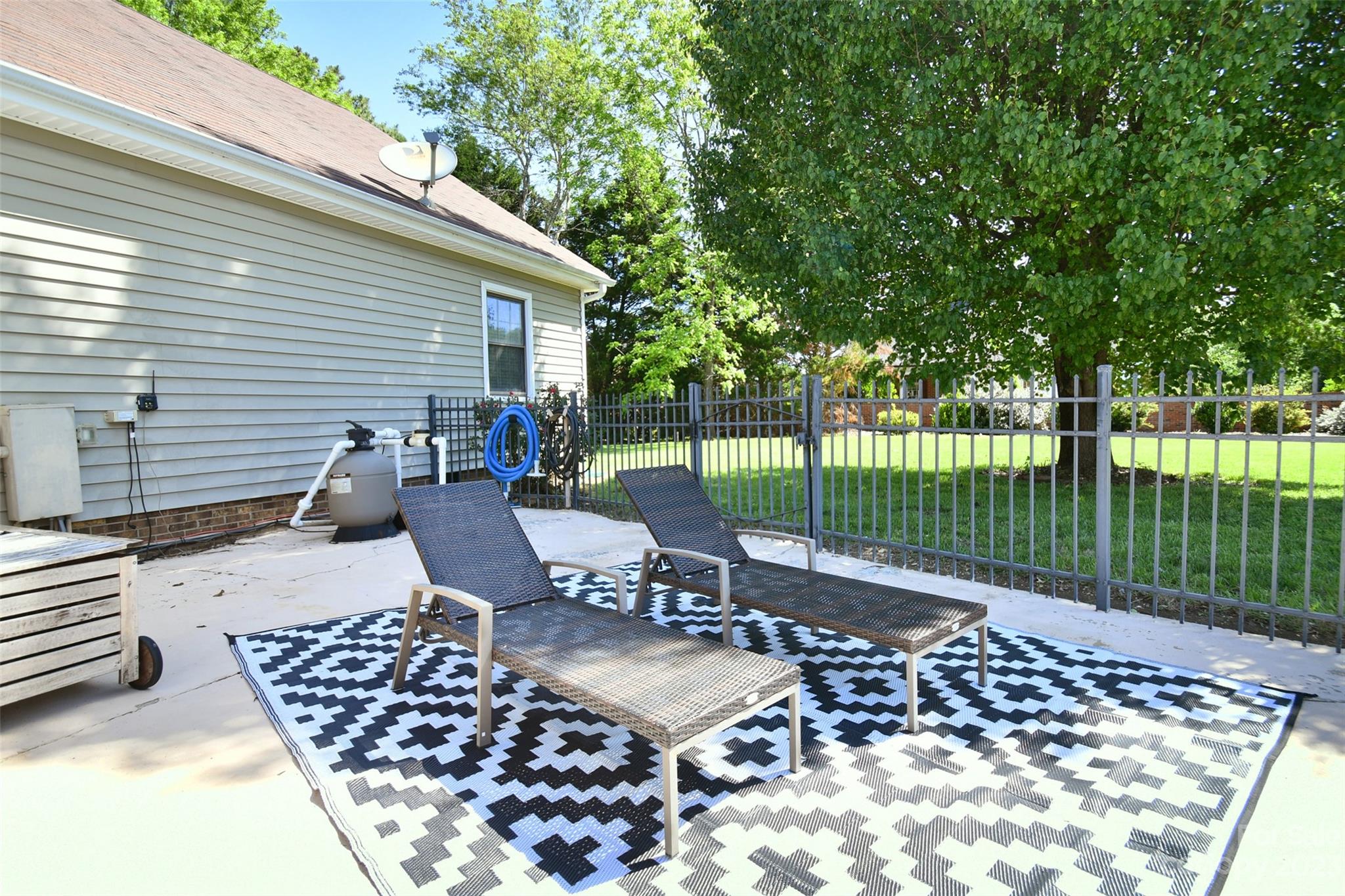 8017 Tottenham Drive Harrisburg, NC 28075 - Photo 31 of 36 a view of a patio with a table chairs and backyard