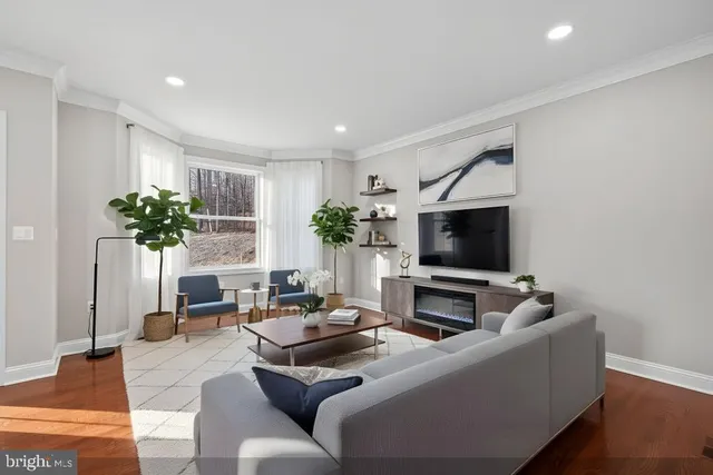 a view of empty room with wooden floor and windows