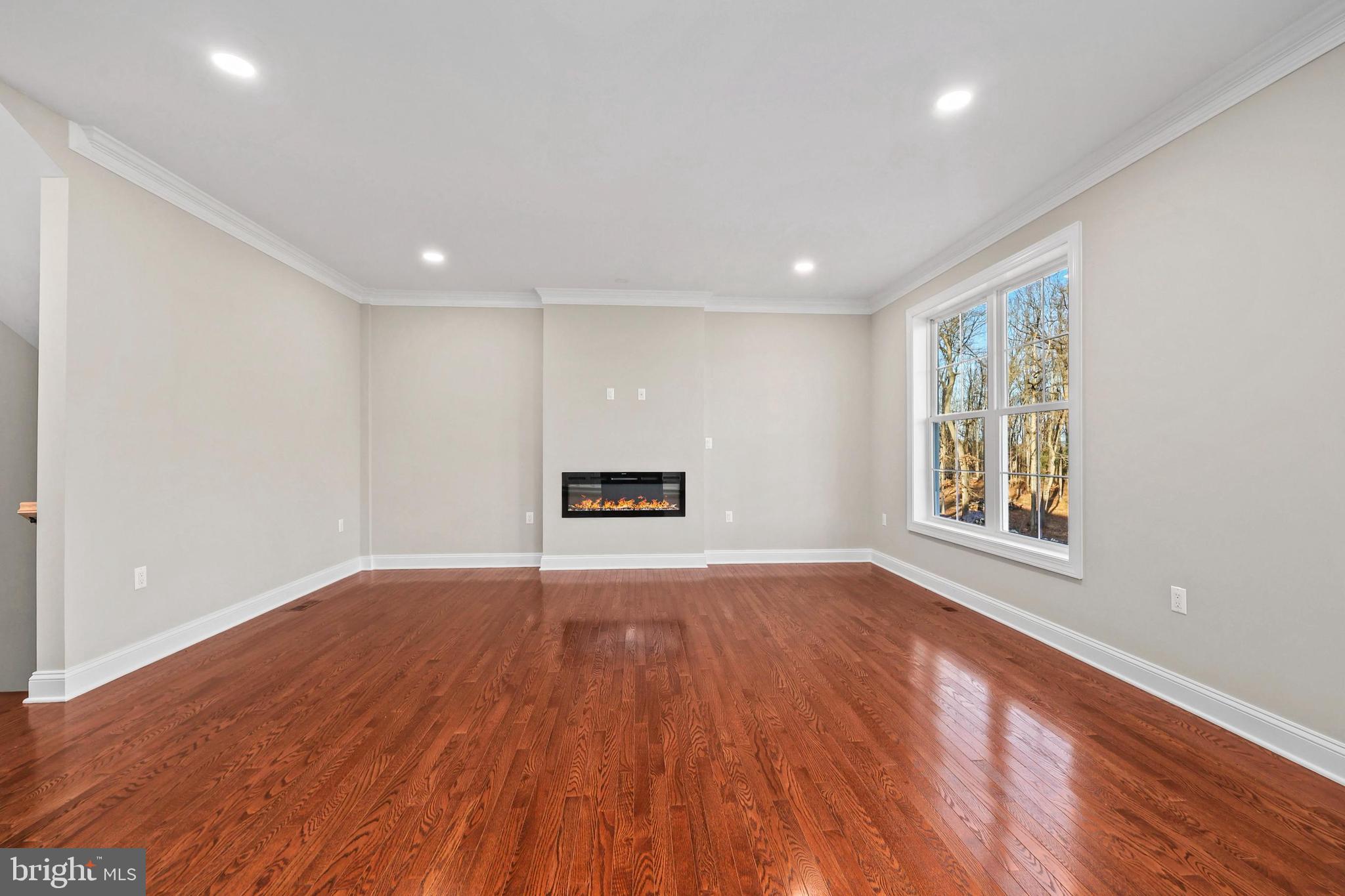 5393 Merry Oaks Road The Plains, VA 20198 - Photo 21 of 58 a view of an empty room with wooden floor and a window