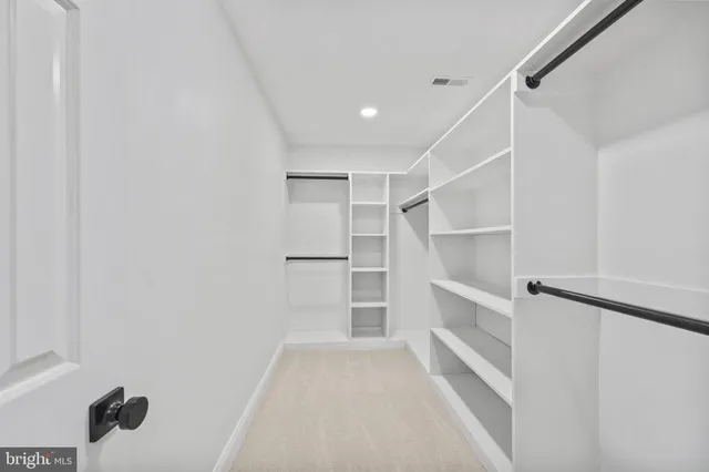 a bathroom with a granite countertop sink toilet mirror and bathtub