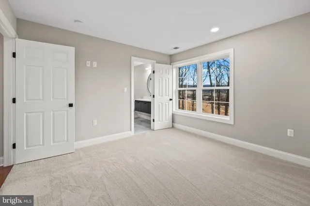 a bathroom with a sink toilet and a mirror