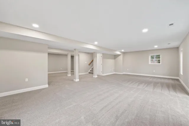 a tall building with a big yard and large trees